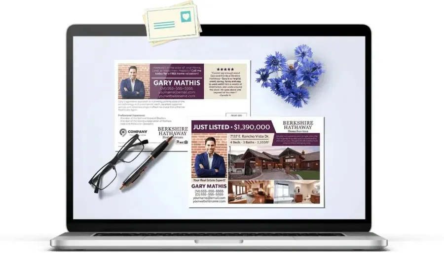 Laptop screen showing real estate marketing postcards with glasses and a pen to the bottom left and flowers to the top right.