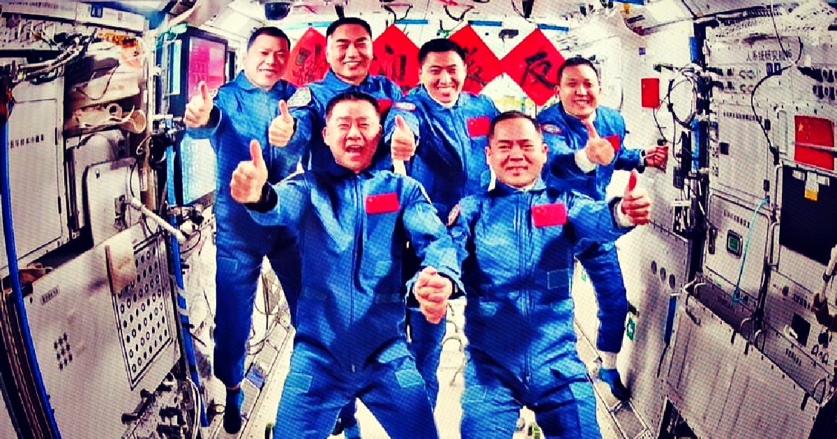 Chinese astronauts celebrate aboard the Tiangong space station, showcasing camaraderie and achievement in space exploration with thumbs-up gestures and festive decorations.