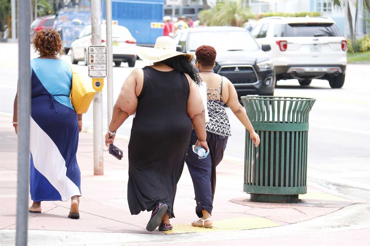 Three women walking on a sunny street, showcasing summer fashion, with a focus on casual attire and vibrant colors in an urban setting.