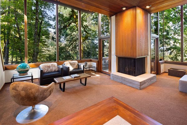 The floor-to-ceiling windows let in sunset light and glimpses of downtown.