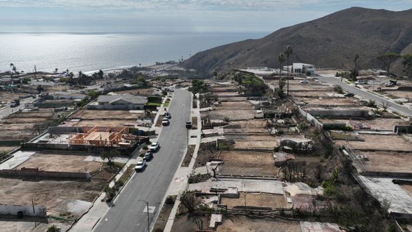 An aerial view of cleared lots and sparse construction after the Palisades Fire in the Sunset Mesa neighborhood of eastern Malibu.