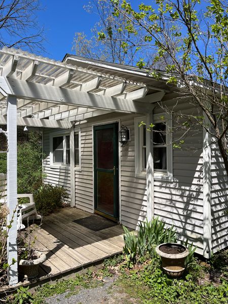 Before: A pergola over the front porch blocked sunlight and created a dark entry.