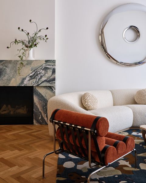 A dramatic stone surround for the hearth keeps to the client’s preferred neutral-forward palette, but adds visual interest, texture, and a bit of warmth, too.