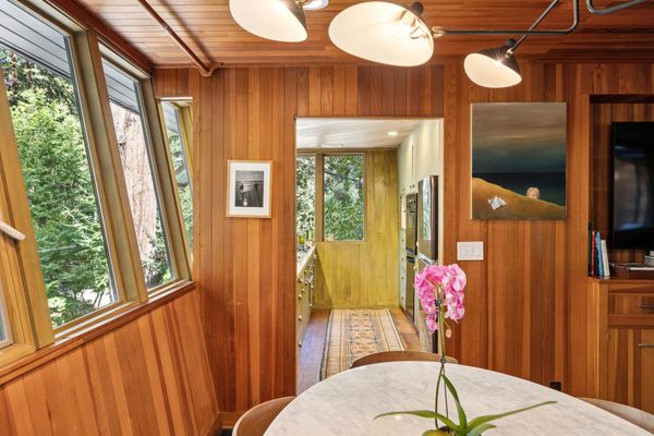 The exterior's angle meets the 90-degree wall inside, meaning a small triangle of open space connects the kitchen and living area.