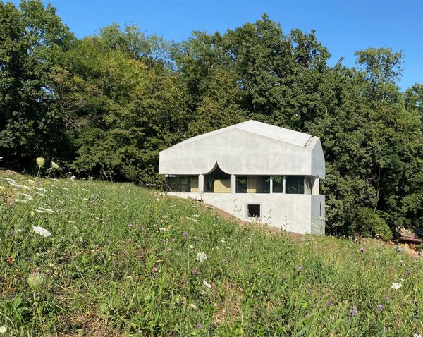 A Ribbon of Windows Wraps This Concrete Cabin in Switzerland