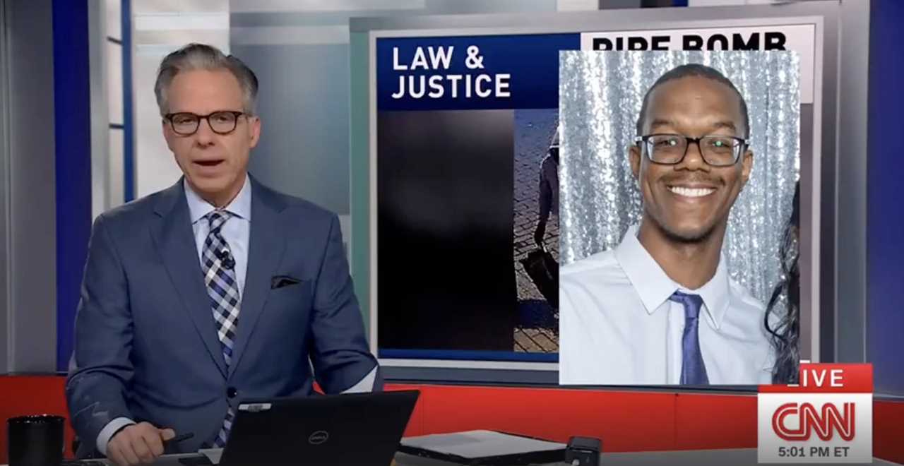 CNN news anchor discusses a breaking story related to law and justice, featuring an image of a smiling man in a formal shirt and tie.