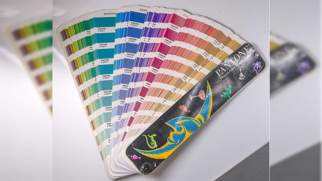 Pantone color guide fan displaying a wide range of vibrant colors for design and printing applications.
