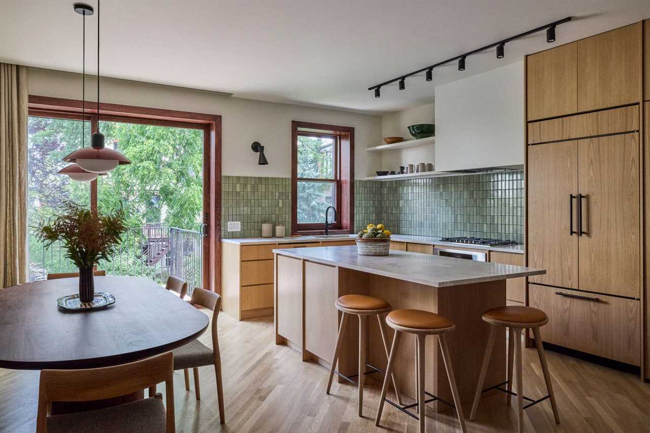 The custom kitchen millwork is designed by reBuild Workshop, and fabricated by Custom Lotus, with quartzite counters. The high stools in white oak are by Space Copenhagen.