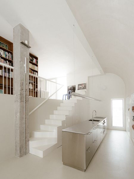 The Staircase in This Small Spanish Apartment Hides a Secret Toilet