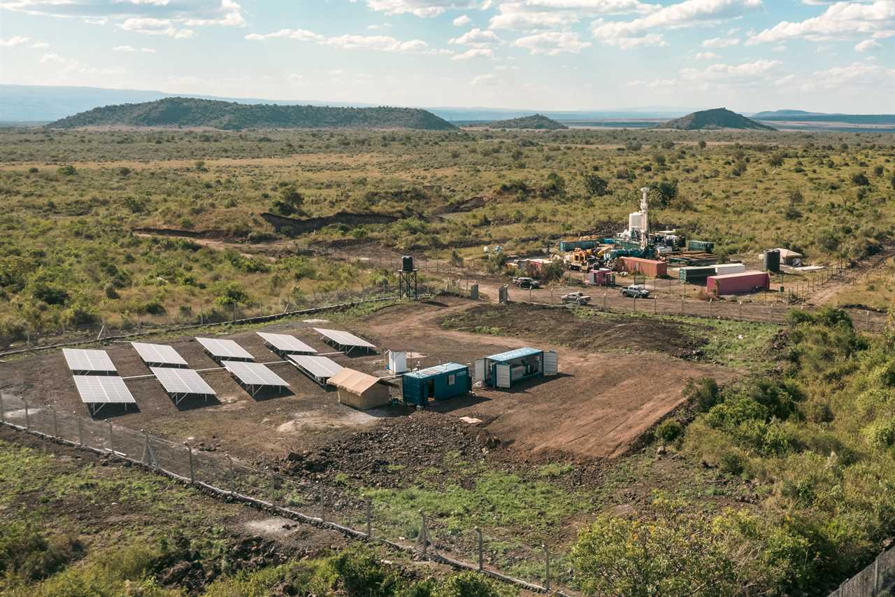 drone view of shipping container buildings next to a solar array