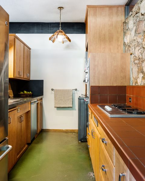 Jade-hued concrete floors span from the living room to the kitchen.