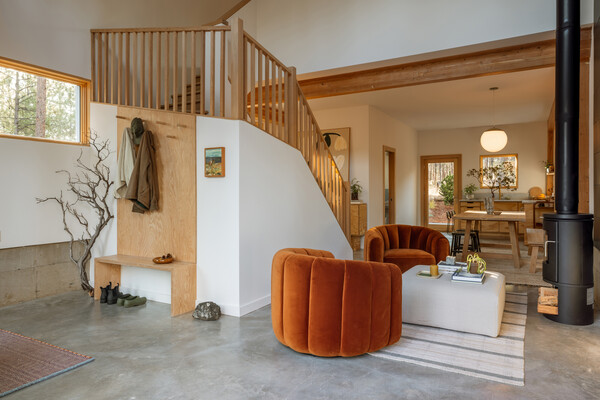 The open-concept living area, a benefit of the Quonset-design, includes velvet chairs from CB2.