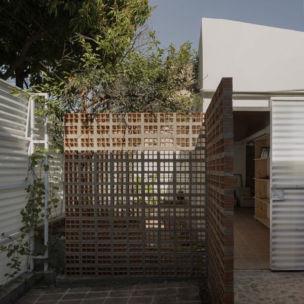 Inside the front door is one of several terra-cotta breeze-block walls that form semiprivate courtyards for each of the property’s units.