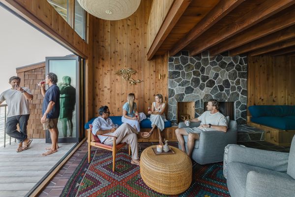 Replacing what was originally a fixed floor-to-ceiling window, bi-fold doors from Lincoln Windows open up the living room to the deck. Designer Amanda Chappell sourced the vintage kilim rug at the Art of Consignment in Santa Barbara.