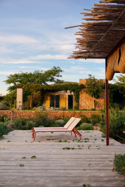 Architect Jaime Romano and his wife, interior designer Roberta Jurado, decided to move to the countryside in northern Ibiza and build a home for themselves, their daughter, Manuela, and Roberta’s mother, Graciela, who often visits from Ecuador. Designed by the couple, the stone-and-plaster Passive House features several patios with pergolas and overlooks a valley of almond trees.