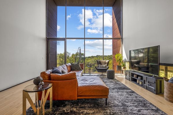 A balcony extends off the main living area, which already is perched above the ground on stilts.