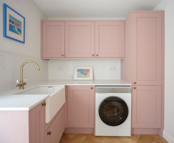 Knight also installed a utility room where the kitchen used to be. The pink cupboards are from Howdens.