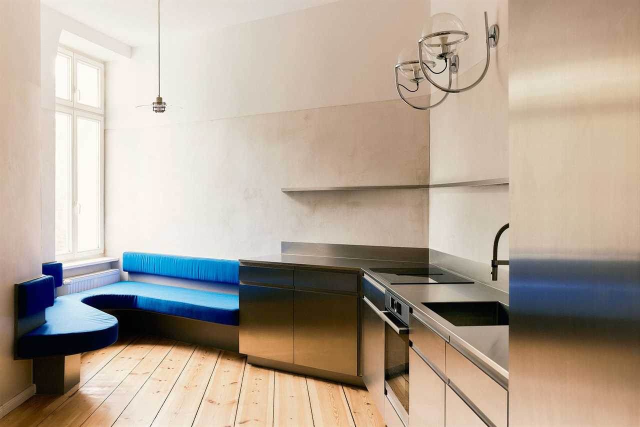 A Curvy Blue Banquette Solves a Tiny Berlin Apartment’s Puzzling Shape