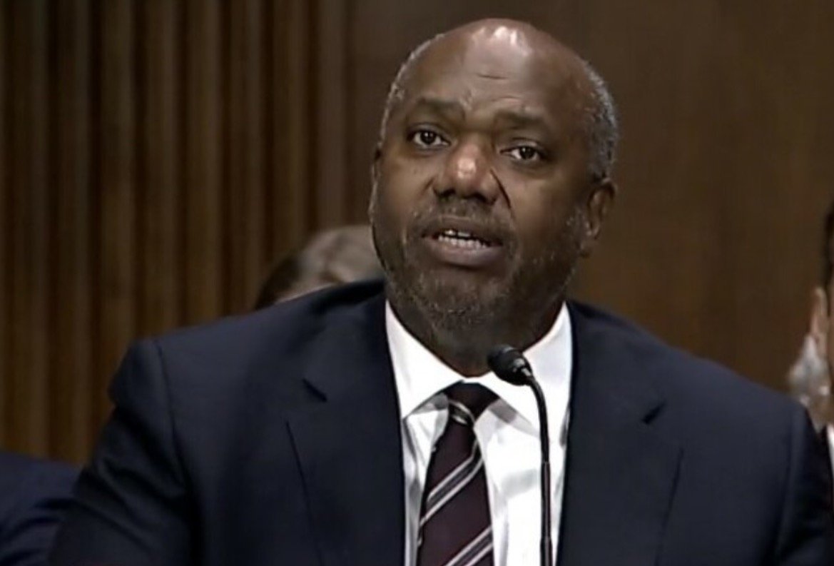 A man in a suit speaks at a Senate hearing, expressing his views on important legislative issues.