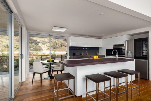 The common areas are on the main floor, with one bedroom upstairs and another on the lower floor.