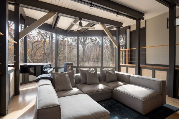 The home features two separate living areas, with a fireplace and wrap-around windows in one.