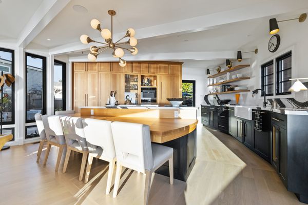 The kitchen is home to custom cabinetry and Wolf appliances.