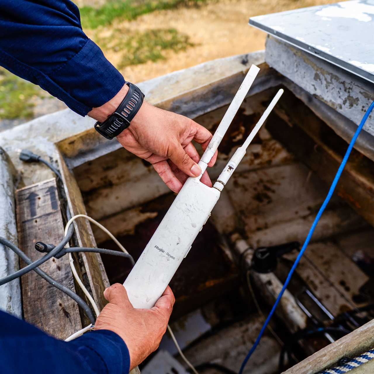 hands holding a Starlink antenna