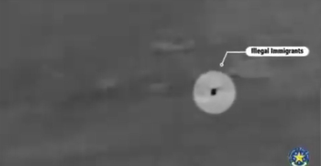 Night vision image showing a group of individuals identified as illegal immigrants, highlighting border security challenges.