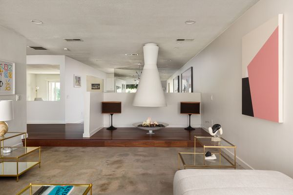 The living room is anchored by a fully-restored Alexander Cone fireplace.