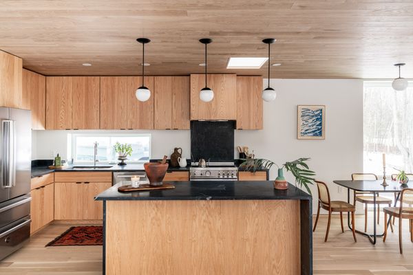 The kitchen features Bertazzoni appliances, custom oak cabinetry, and soapstone counters.