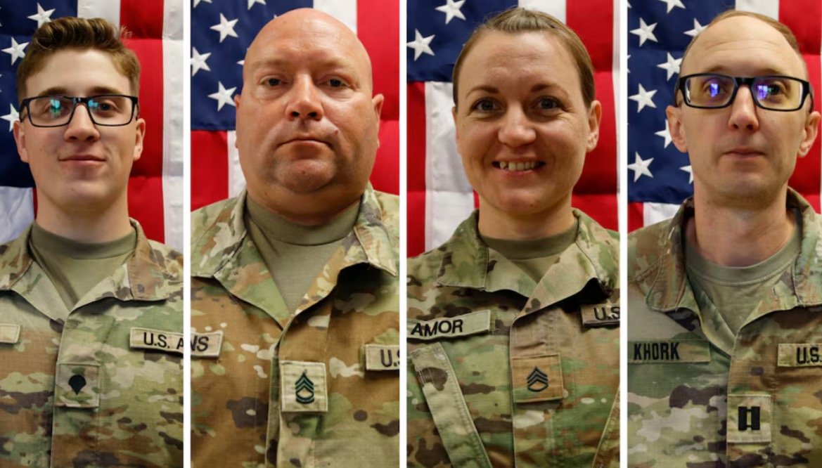 Four U.S. service members in military uniforms pose for a portrait against a backdrop of the American flag, showcasing their camaraderie and dedication.