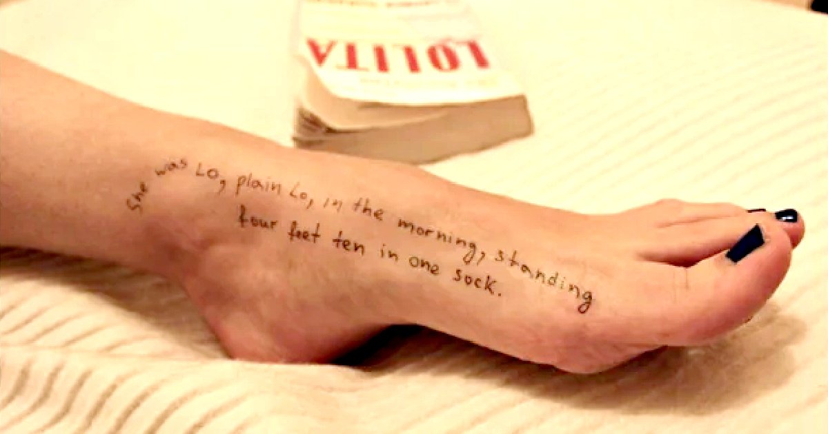 Foot with handwritten text and a book in the background, showcasing a unique artistic expression and literary reference.