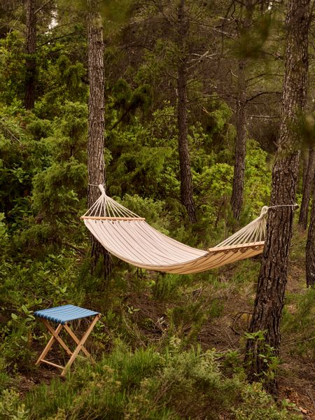 The collection's hammock is available in blue, black, or red stripes.