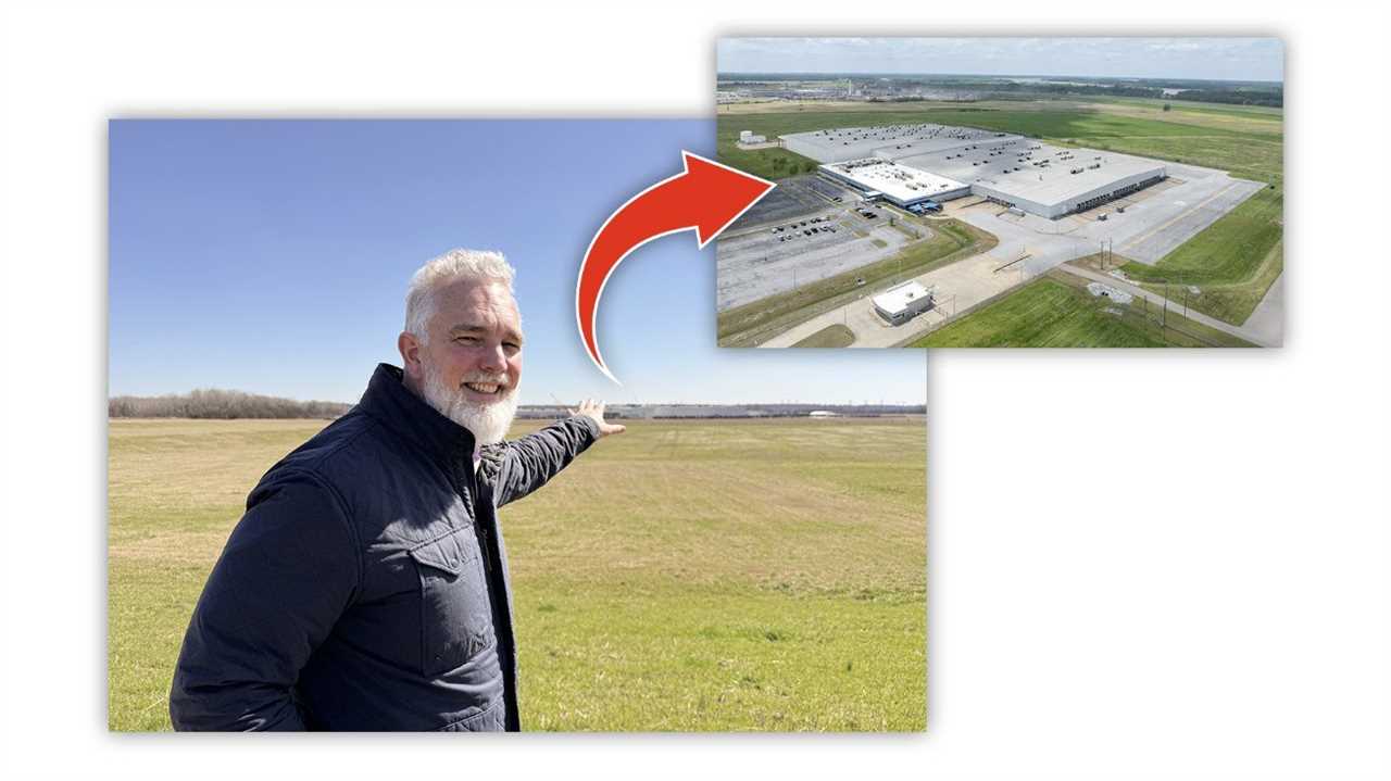 Man pointing towards a large industrial facility on a clear day, showcasing the expansive landscape and building location.