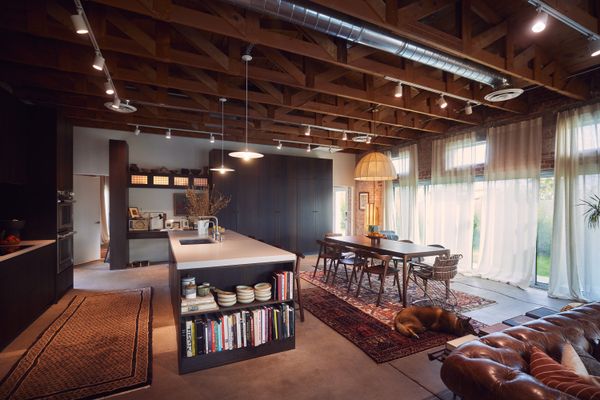 The Bok teak dining set from Ethnicraft is paired with vintage Gastone Rinaldi steel-and-suede chairs.