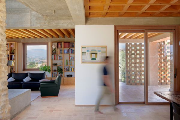 Heated brick floors are underfoot, with oak joinery adding warmth to the exposed concrete beams.
