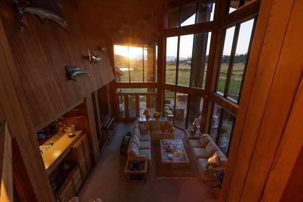 The great room is double height, with oversized windows to match.