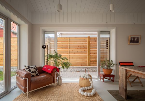 The living annex’s design is straightforward, but feels warm and interesting thanks to materials like linoleum floors from Forbo in the colorway Indigo Milk, a beadboard ceiling with materials from Dyke’s Lumber, and a jute rug from One King’s Lane.