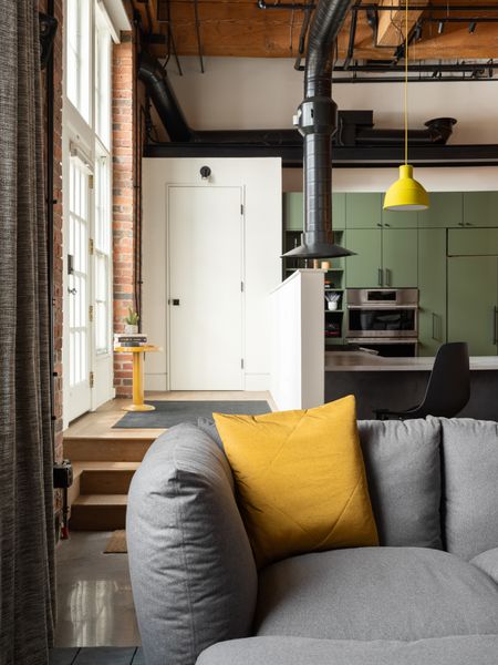 Roth kept the entry elevated and added a coat closet and half wall, which acts as a "cap