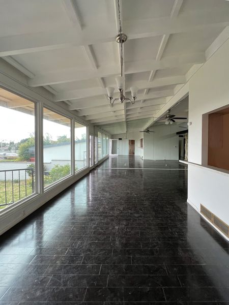 Before: The renovation sought to remove layers of faux finishes that had been added over the years, including a wall of mirrors and a faux stone wall around the fireplace in the living room.