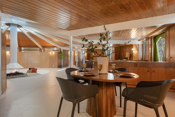 Pre-renovation, the home was awash in blue, with blue carpet flooring and structural beams—both of which are now white.