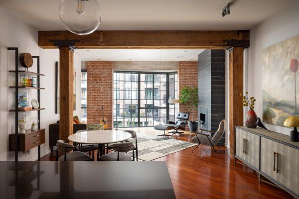 Beneath the home's vaulted ceilings, are the original factory's wood beams and brick accents.