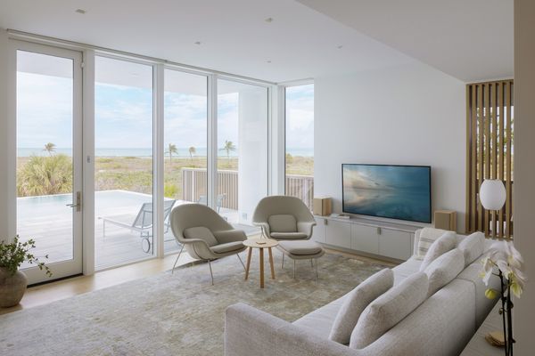 The living space takes in views of the water through special glass, designed to temper light so as not to lure baby turtles in the wrong direction—an issue with beachfront properties in the area.