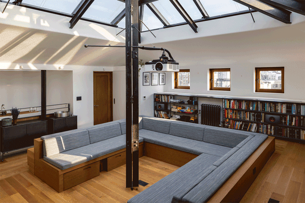With a few short steps, the conversation pit in the library upstairs becomes space for family to sleep.
