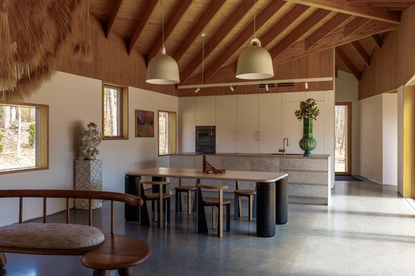 Polished concrete floors connect the living, dining, and kitchen areas.