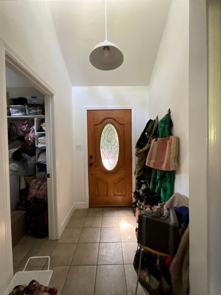 Before: The original foyer lacked closed storage, so it was easy for items to accumulate.