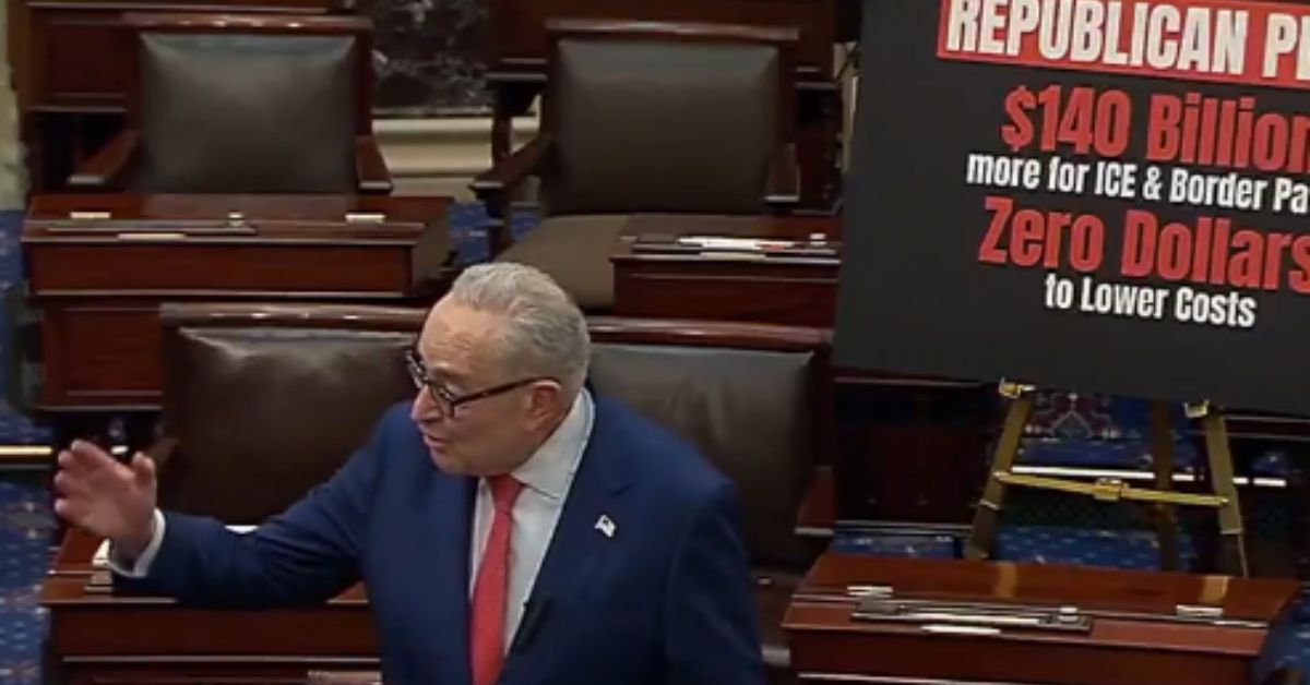 Senator Chuck Schumer speaks in the Senate chamber, addressing funding for ICE and border policies, with a sign highlighting proposed budget allocations.