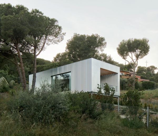 Wood Prefab Panels Cloaked in Galvanized Steel Form a Hillside Home in Barcelona