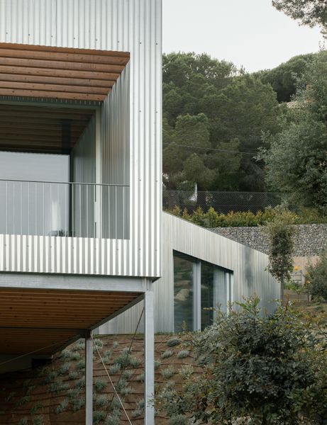 Wood Prefab Panels Cloaked in Galvanized Steel Form a Hillside Home in Barcelona
