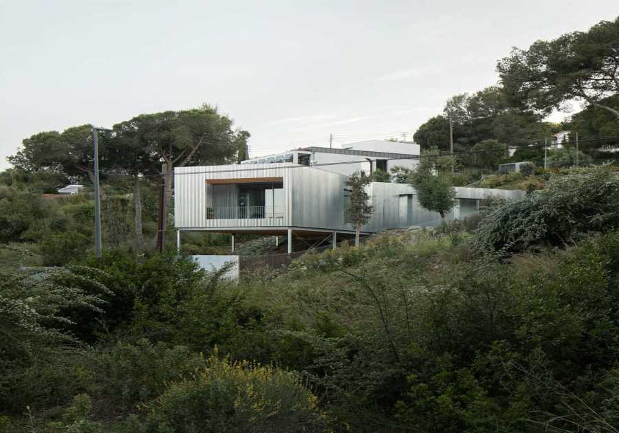 Wood Prefab Panels Cloaked in Galvanized Steel Form a Hillside Home in Barcelona